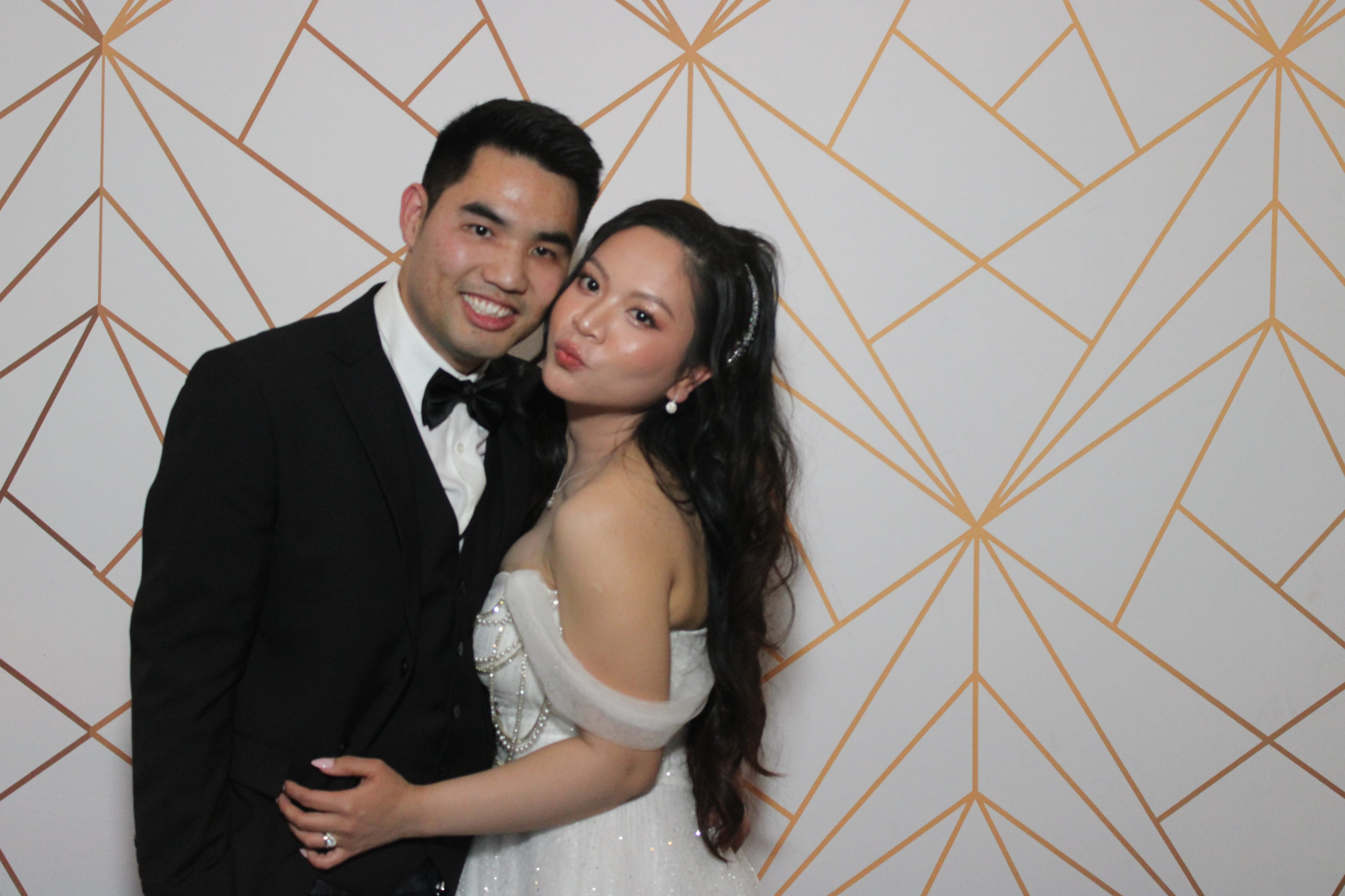 Wedding couple, alternate pose on gold geometric backdrop